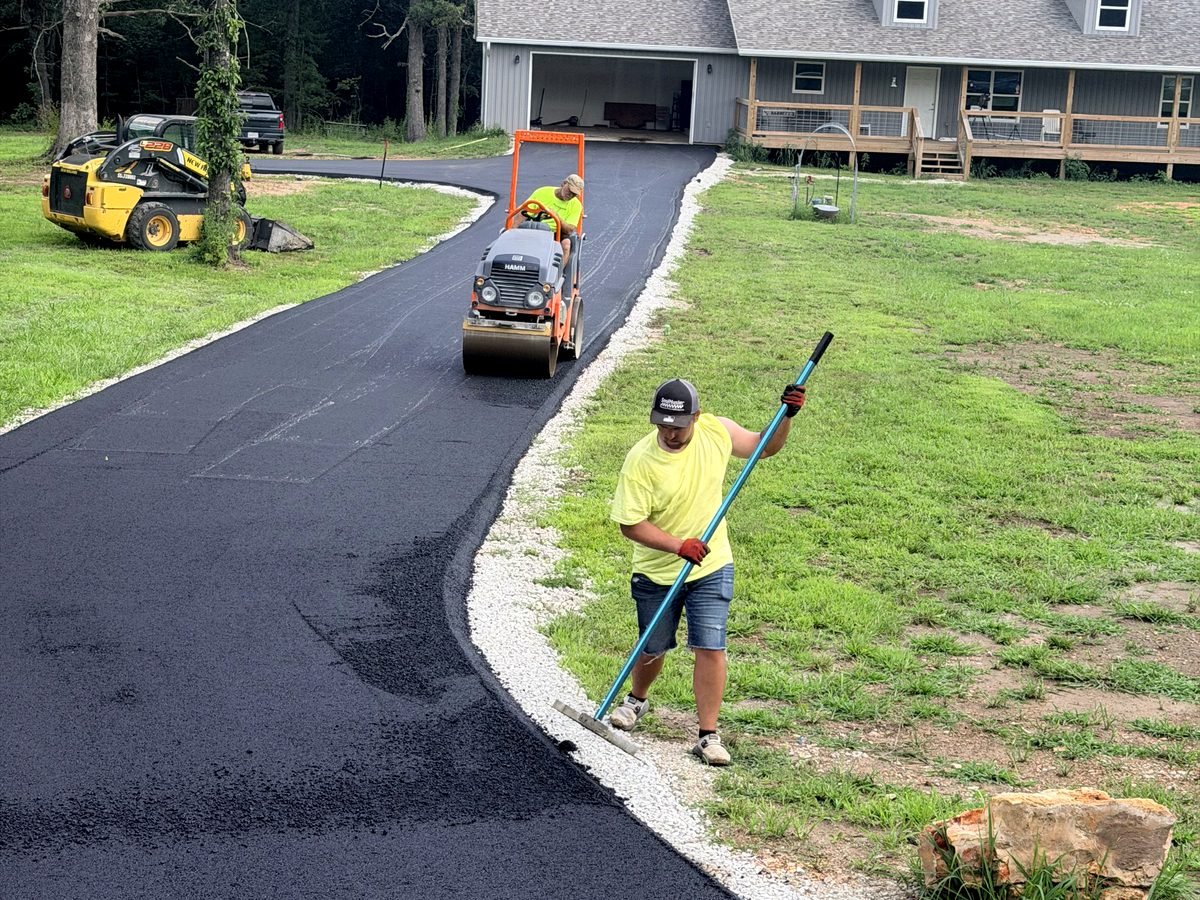 MT Pavers crew compacting fresh hot-mix asphalt